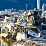 Devastation in Iwate: aftermath of natural disaster in Japan, vehicles piled up on waterfront.
