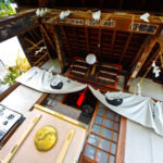 Traditional Japanese shrine interior with wooden beams, lanterns, and serene atmosphere in Tokyo.