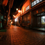Discover the enchanting alleyways of historic Shibu Onsen, Japan, filled with lantern-lit wooden buildings.