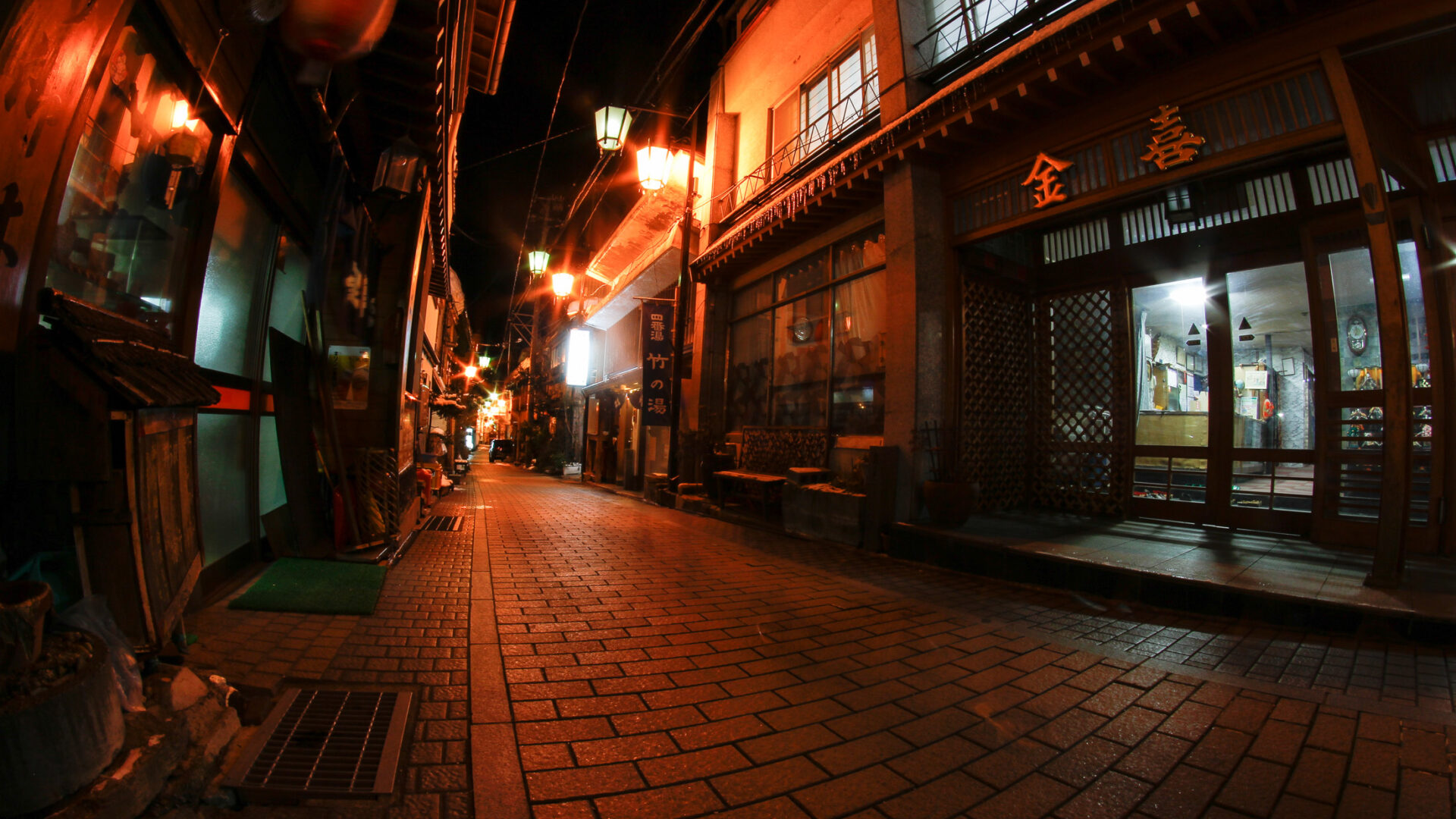 Discover the enchanting alleyways of historic Shibu Onsen, Japan, filled with lantern-lit wooden buildings.