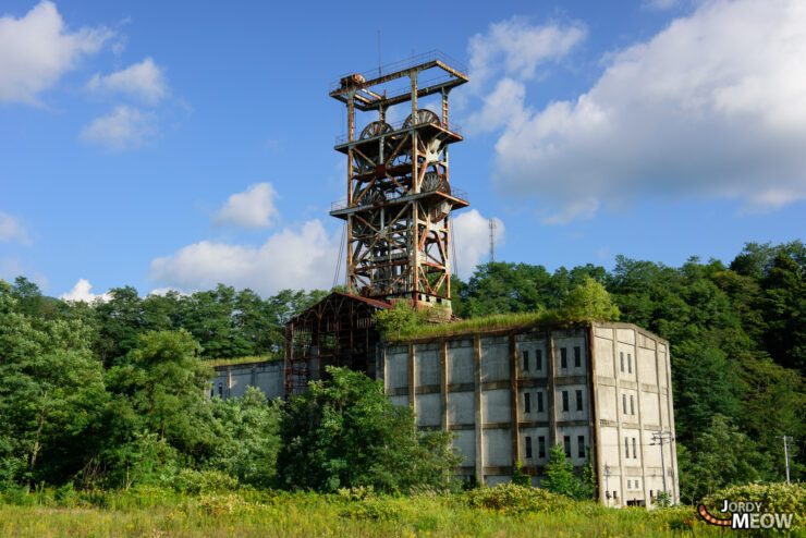 Explore abandoned Sumitomo Coal Mine in Hokkaido, Japan - decaying beauty surrounded by lush vegetation.