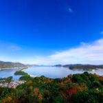 Awe-inspiring Amanohashidate sandbar with lush surroundings and majestic mountains in Japan.