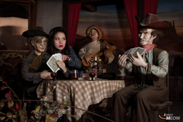 Cowboy group playing cards at deserted Western Village, Japan.