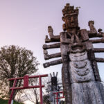 Intricately carved multi-armed wooden deity statue at Japanese shrine