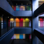 Soho Odaiba Tokyo atrium with multi-level concrete walkways and rainbow wall panels