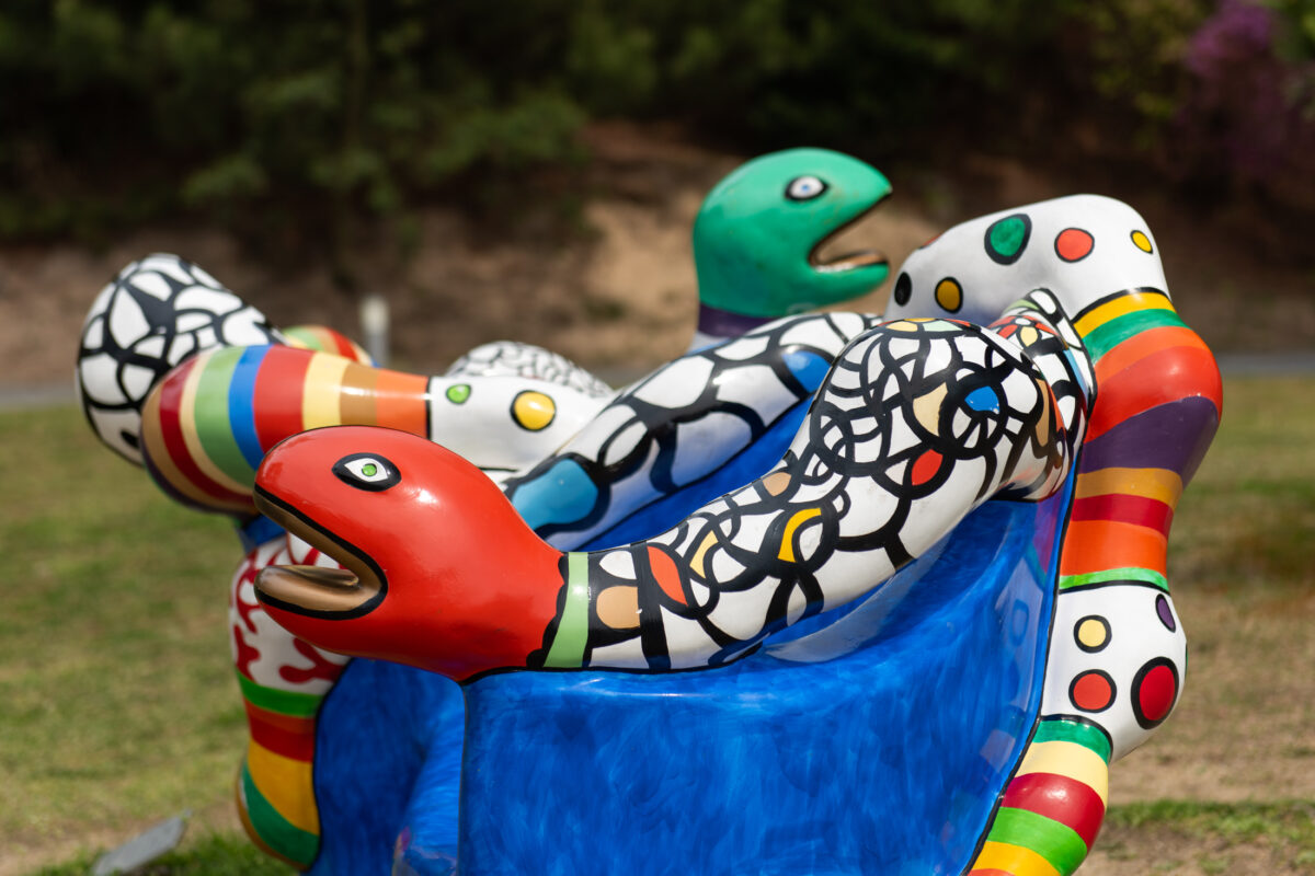 Colorful abstract sculpture at Naoshima Art Island, Japan, in a grassy park setting.