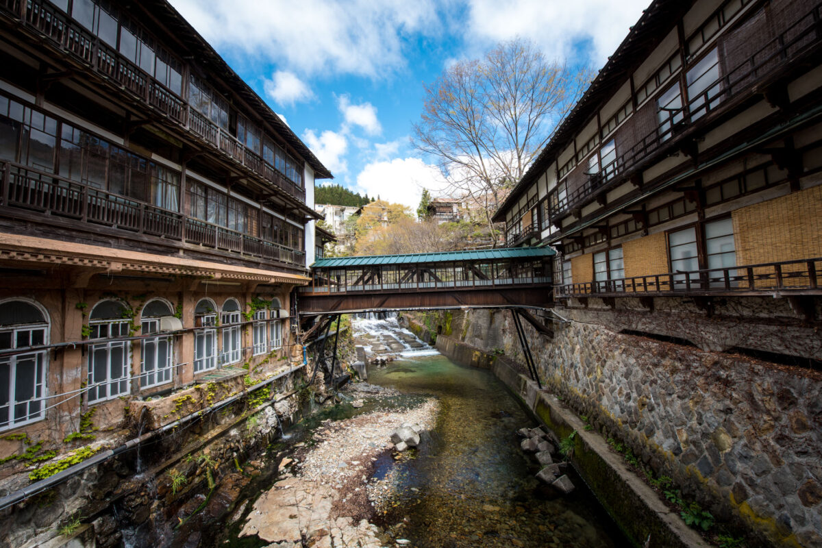 Sekizenkan Ryokan wooden buildings over river gorge, connected by enclosed bridge in Japan