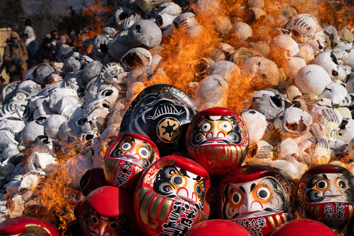 Ceremonial burning of Daruma dolls at Shorinzan Temple, Japan, with flames and smoke