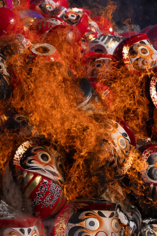 Daruma dolls burning in ritual fire at Shorinzan Temple, Japan