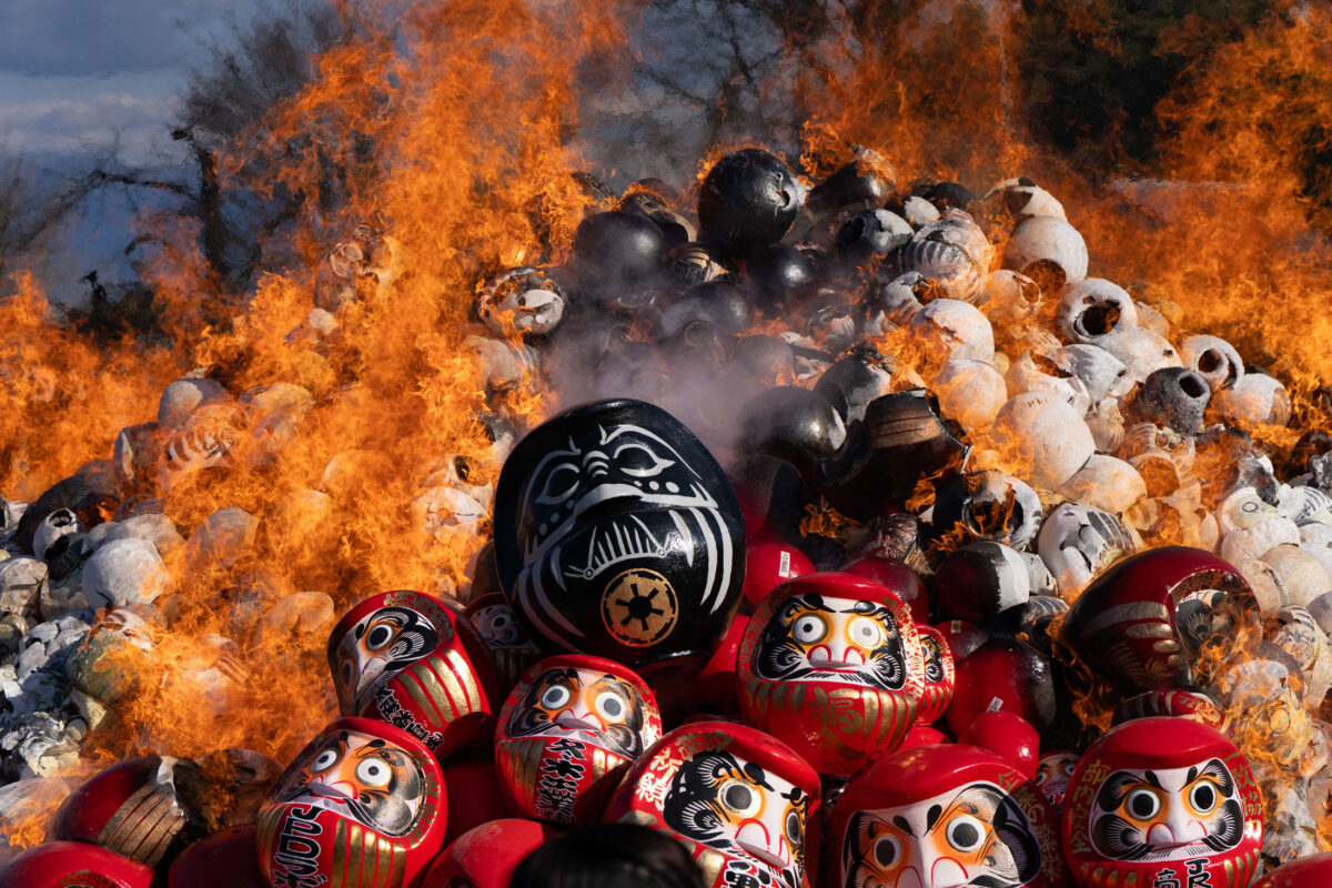 Daruma doll burning ceremony at Shorinzan Temple, Japan, with flames and smoke