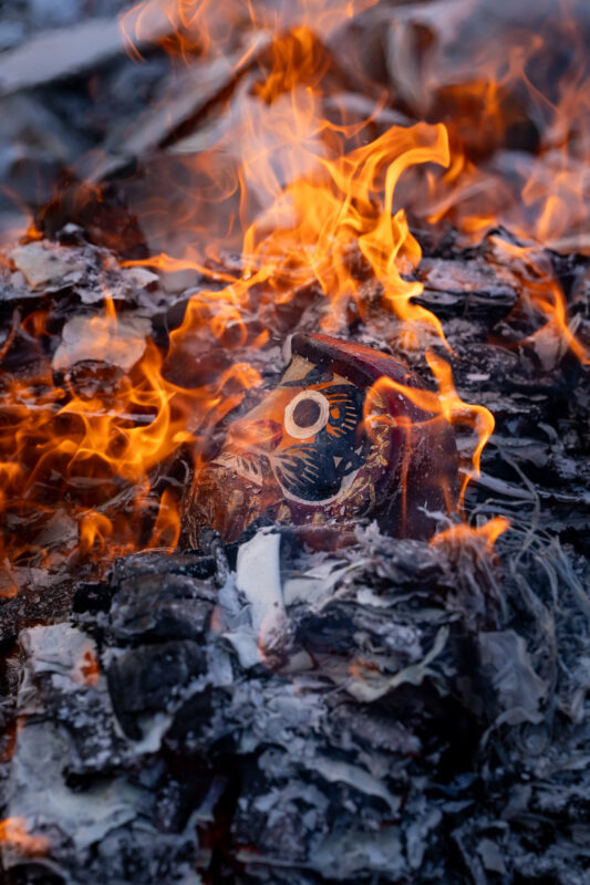 Daruma doll burning in ritual fire at Shorinzan Temple, Japan